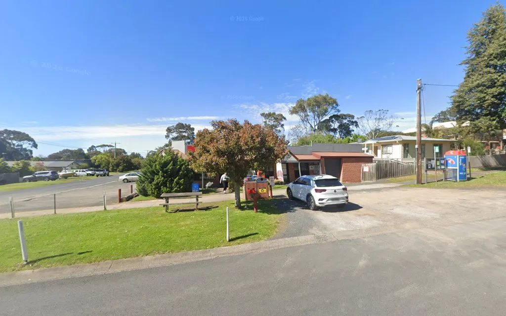 Wide-angle exterior view of RHYLL General Store in its Rhyll neighbourhood context with park and gum trees
